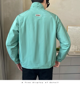 Detail showing elastic cuffs and 1989 rectangular label on light green casual jacket