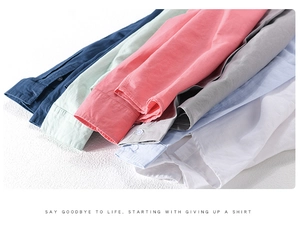 Detail showing various colors and natural cotton linen fabric texture of long sleeve shirts