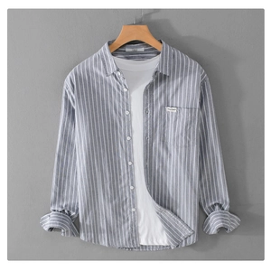 Detail of grey striped long-sleeve cotton shirt with chest pocket and white t-shirt