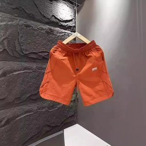 Men's bright orange quick-dry casual shorts with elastic drawstring waist and logo