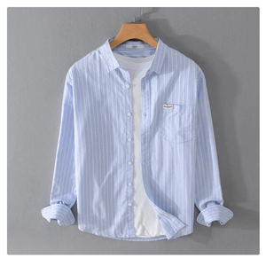 Close-up of blue striped shirt collar with large size label and white inner tee