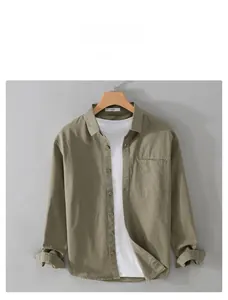 Detailed macro view of olive green cotton linen shirt texture and front chest pocket
