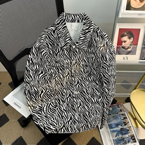 Close-up of zebra pattern denim jacket with pointed collar and chest flap pockets