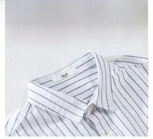 Detail view of striped cotton shirt featuring a classic collar and neat white buttons