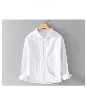 Close-up of white linen shirt fabric texture and collar details on wooden hanger