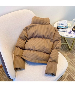 Close-up of brown puffer jacket with unique pleated texture and high-standing collar