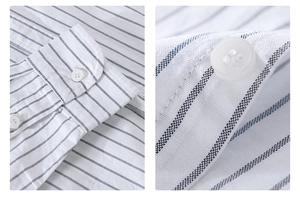 Detail of white cotton shirt with fine blue stripes showing fabric texture and buttons