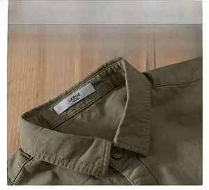 Detail shot of army green cotton twill shirt collar with neat stitching and button