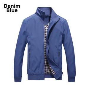 Detail of denim blue jacket showing stand collar, zipper pockets and plaid lining