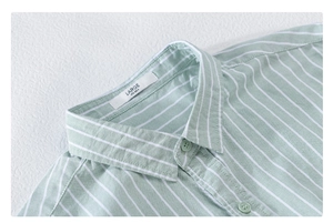Close-up of mint green striped shirt collar and fabric texture with size L label