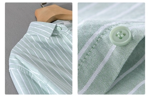 Detail view of light green striped cotton shirt fabric with button and size L label