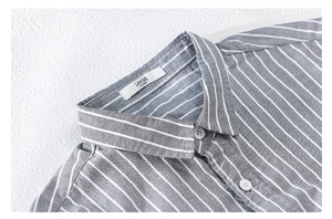 Detail shot of a grey and white striped shirt collar with a size large label