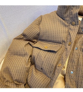Detail of brown quilted puffer jacket featuring high collar and metallic buttons
