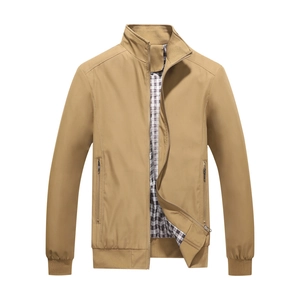 Detail of khaki men's stand-collar jacket with ribbed cuffs and black and white plaid lining