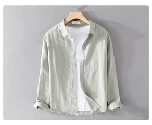 Detail of light green linen long sleeve shirt with natural texture on a wooden hanger