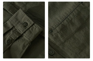 Detail of olive green cotton twill work shirt with button closure and reinforced stitching