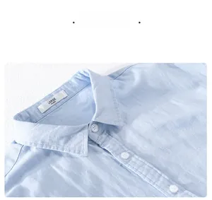 Detail view of light blue linen shirt collar showing fabric texture and size label