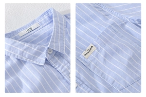 Macro detail of light blue striped shirt collar label and chest pocket stitching