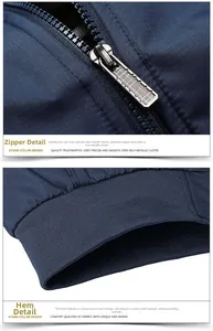 Detailed macro view of polished metal zipper and elastic ribbed hem on navy jacket