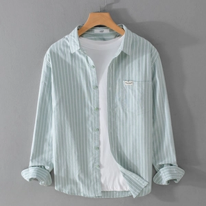 Men's light mint green striped long-sleeve cotton shirt with chest pocket on wood hanger