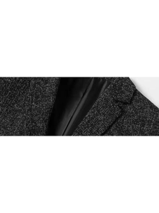Detailed close-up of a men's slim fit black tweed blazer with notched lapels and satin lining