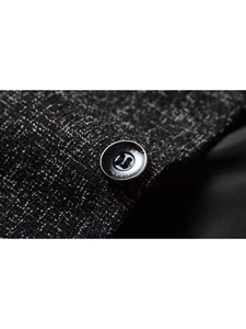Close-up of a black textured blazer featuring a polished button with Class engraving