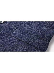 Macro shot of dark blue textured polyester blazer fabric showing pocket and stitching