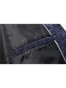 Detail of the inner suit pocket featuring blue and white tweed trim and smooth lining