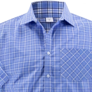 Detail of blue plaid shirt featuring button-down collar and chest pocket with sharp texture