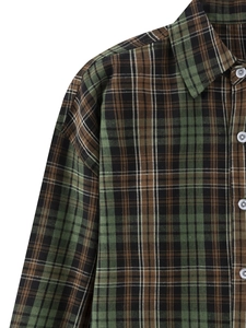 Detailed close-up of plaid long sleeve shirt with green and brown checkered pattern