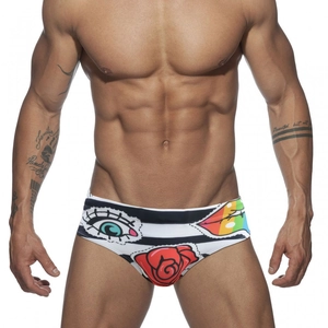 Men's low-waist swim briefs with black and white stripes and colorful tattoo patterns