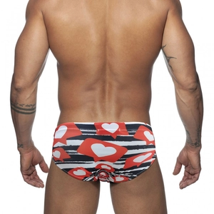 Men's low-waisted swim briefs with black white stripes and red heart print design