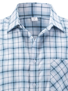 Close-up of men's plaid shirt collar and pocket with blue, white, and black check pattern