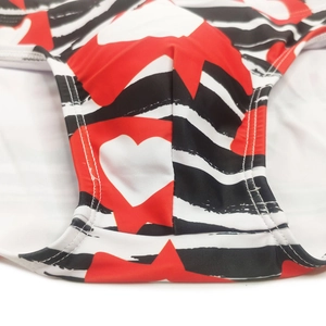 Macro detail of men's heart and stripe swim briefs showcasing stitching and fabric texture