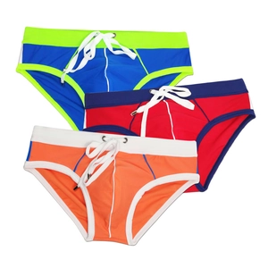 Detailed view of men's color-block swim briefs with elastic waist and adjustable drawstring