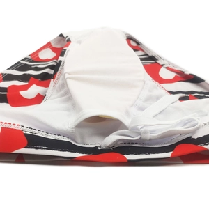 Detail of men's swim briefs with red and black abstract print and white drawstring tie
