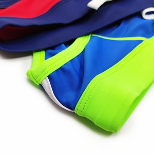 Close-up of elastic multi-color patchwork swim briefs with neat double-stitching detail