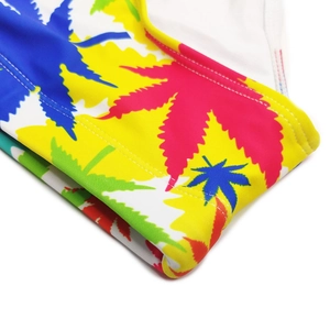 Close-up of vibrant maple leaf prints and durable double-stitched seams on swim briefs