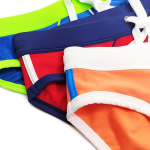 Close-up of contrast color swim briefs featuring elastic waistbands and white drawstrings