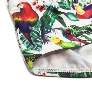 Détail du maillot de bain avec imprimé oiseaux tropicaux et coutures de haute qualité
