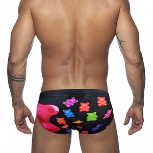 Back view of men's black swim briefs featuring colorful gummy bear prints and pink heart