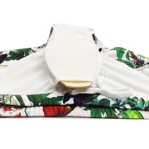 Detail of tropical floral bikini bottom featuring removable padding and white inner lining