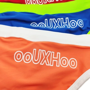Close-up of colorful men's swim briefs with elastic texture and contrast white piping