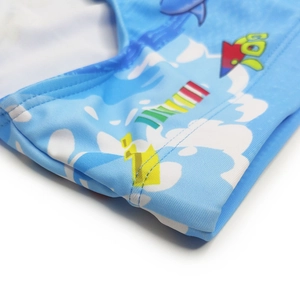 Close-up of blue swim briefs with rocket and dolphin print and durable double-stitched seams