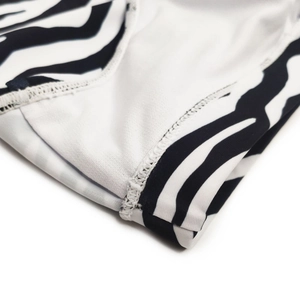 Macro shot of zebra print swimsuit fabric showing precise stitching and elastic texture