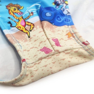 Detail view showing stitching and giraffe cartoon pattern on blue men beach trunks