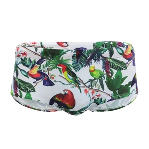 Men's swim trunks featuring tropical parrot and floral prints on a white background