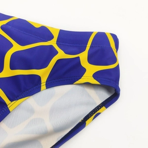Detailed macro view of men swimming briefs with blue and yellow giraffe print patterns