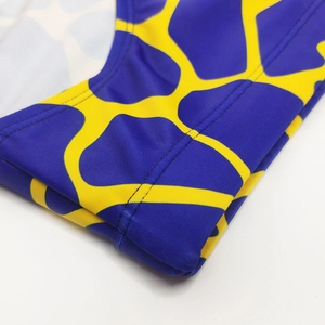 Close-up of double-needle stitching on high-elastic giraffe print swim trunks