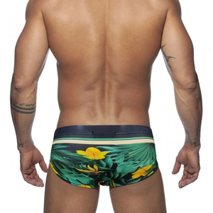 Men's low-rise swim briefs with tropical green leaves and yellow hibiscus floral print